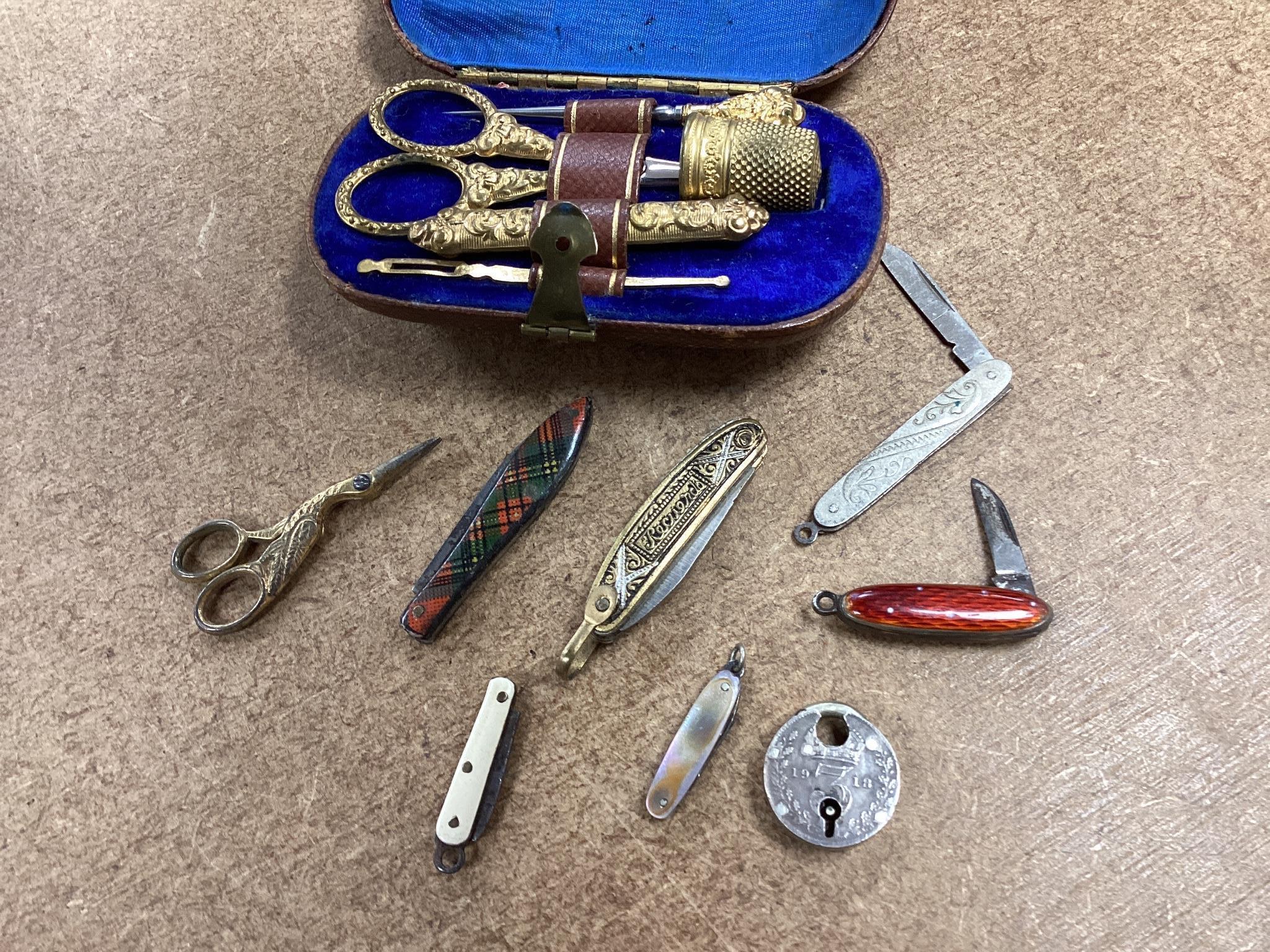 A quantity of various collectables to include a Victorian cased gilt metal etui a 9ct gold mounted boxwood toothpick case, various snuff boxes, miniature penknives, enamelled decanter labels etc.